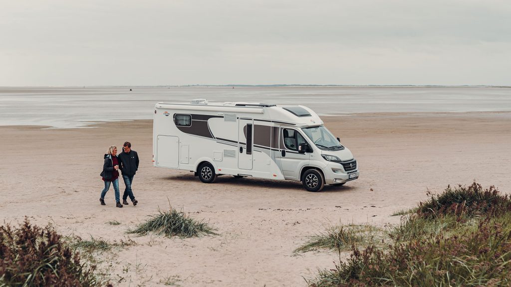 Carado T 447 parked on the beach with couple next to it